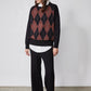 Black crewneck argyle sweater with rust diamond pattern, long sleeves