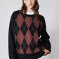 Front close-up of black argyle sweater with rust-brown diamond pattern