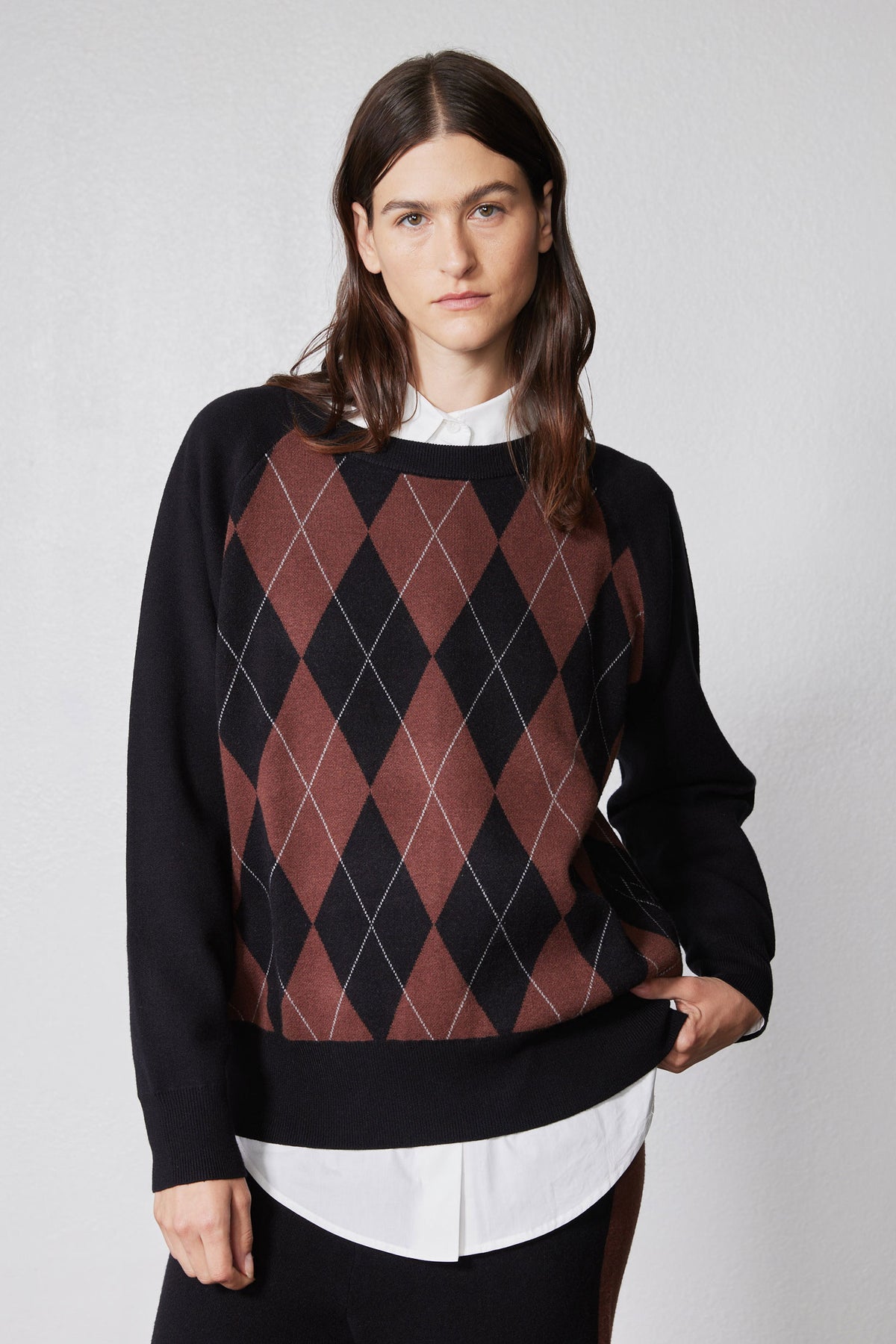 Front close-up of black argyle sweater with rust-brown diamond pattern