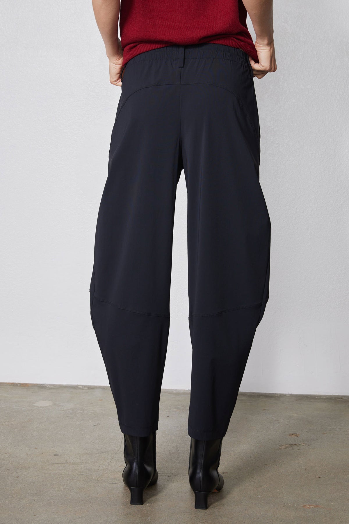 Wide-ish dark navy pants, back view with center seam and relaxed wide legs