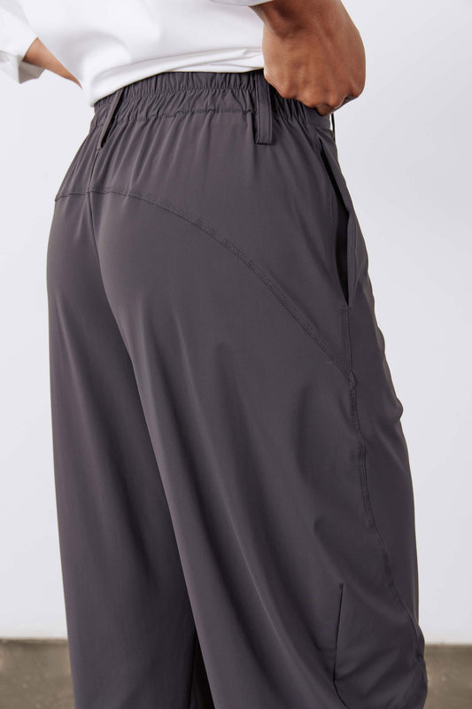 Wide-ish pants in graphite, close-up of elastic waistband and curved side panel