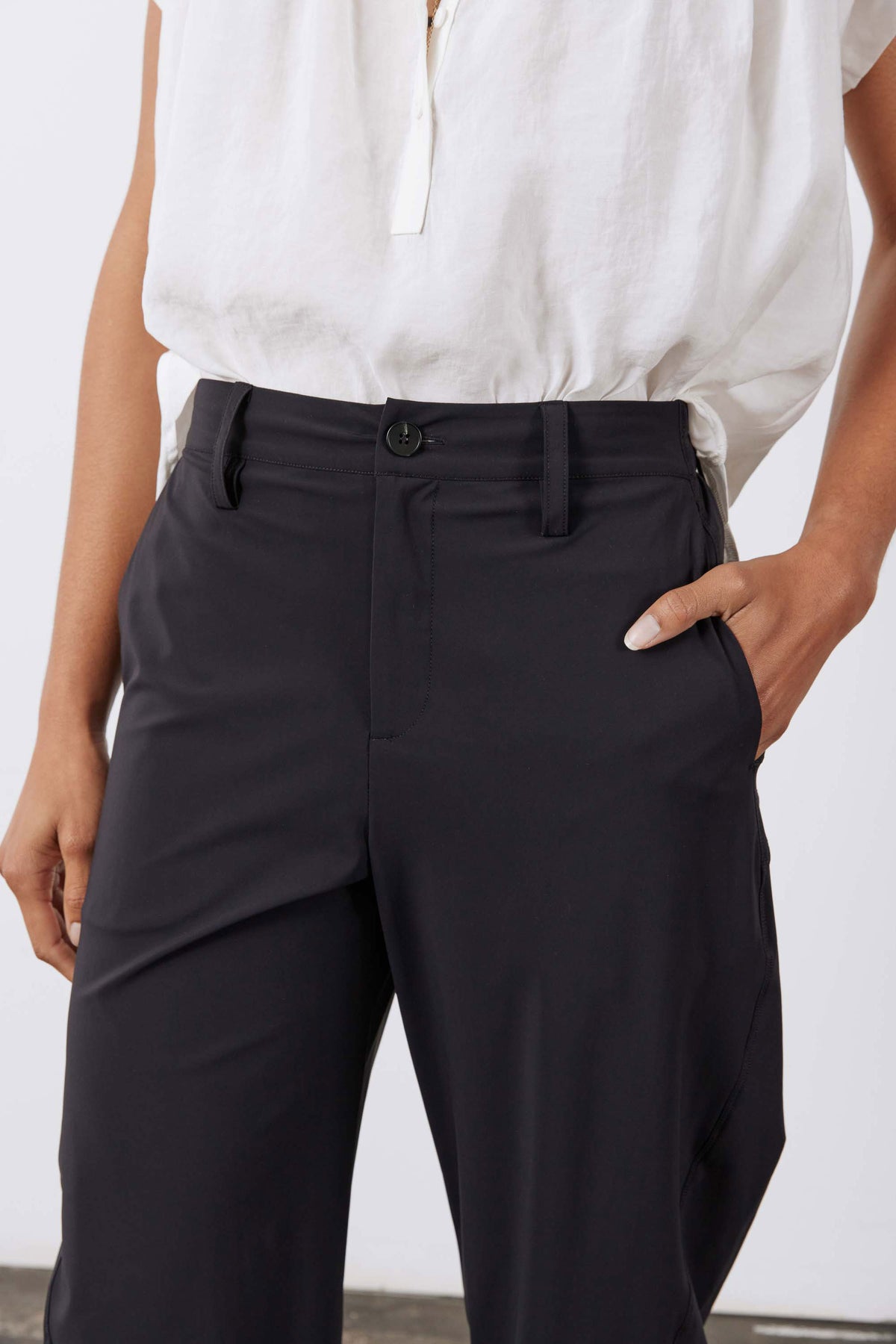 Black wide-fit pants with button front, belt loops, and side pockets