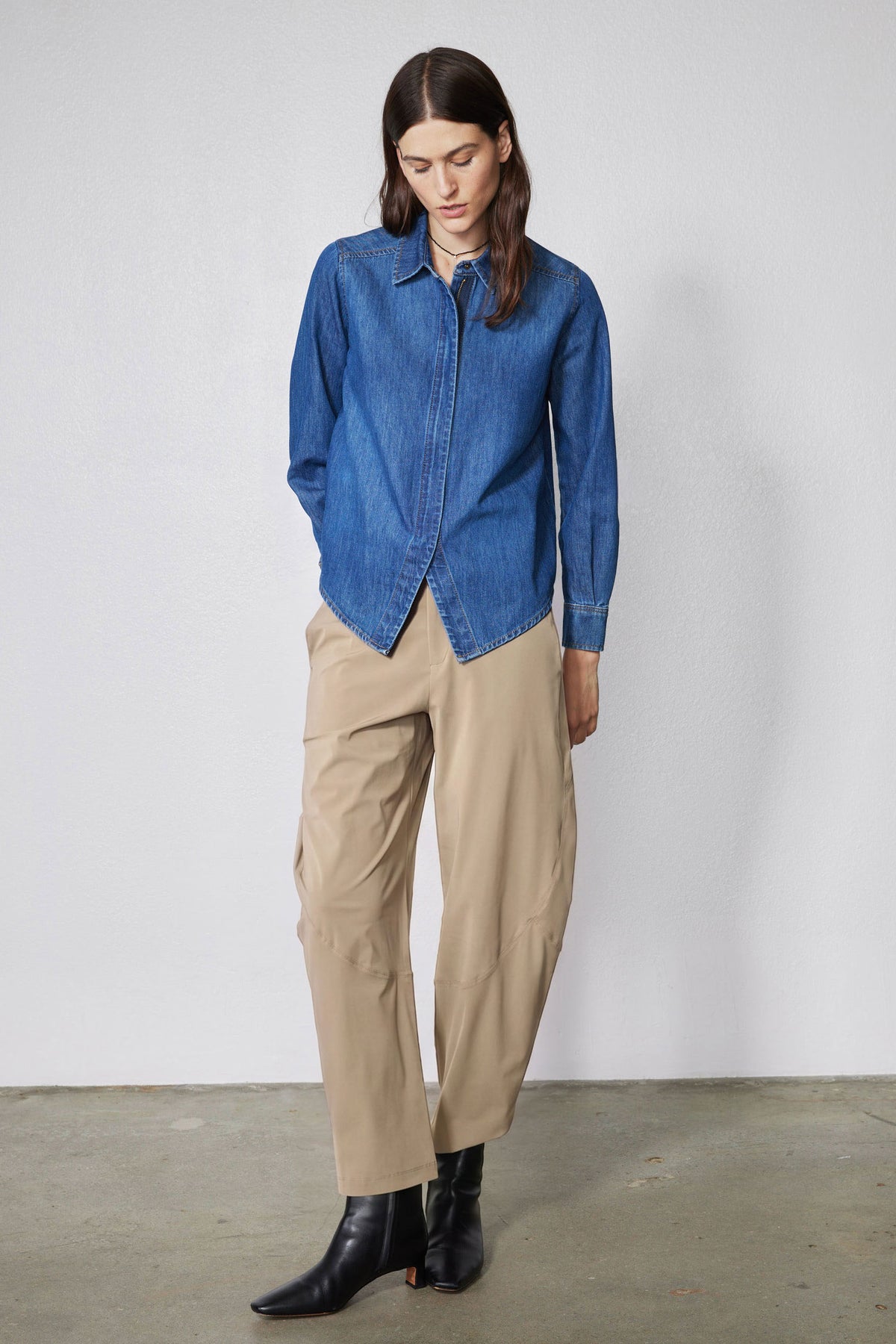 Tan wide-leg pants with elastic waistband, side pockets, and ankle-length.