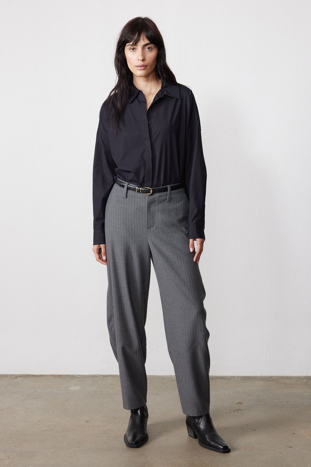 Gray pinstripe wide-leg suit pants with belt loops and cuffed hem, front view