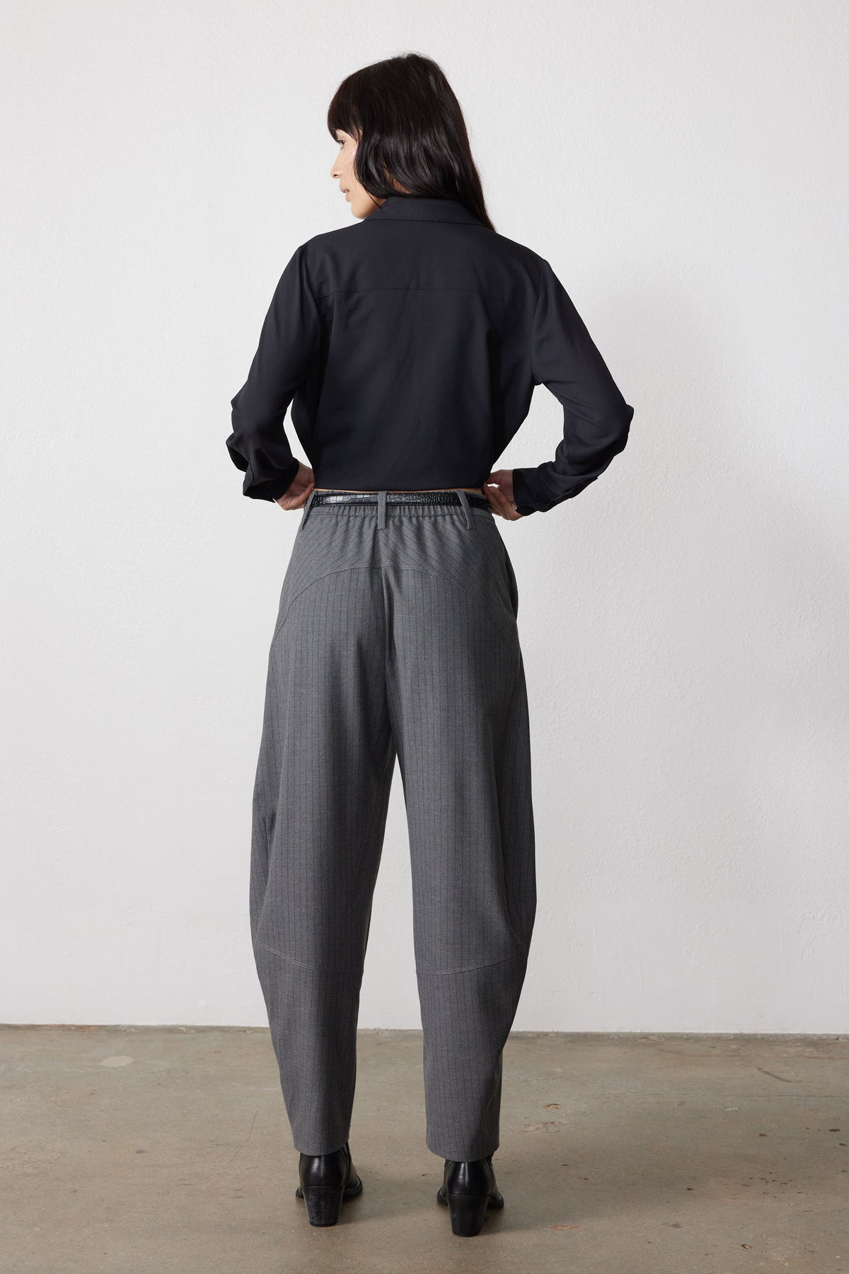Gray pinstripe wide-leg suit pants, back view with belt loops and cuffed hem
