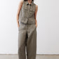 Olive green cropped task vest with button front and two chest pockets, model standing
