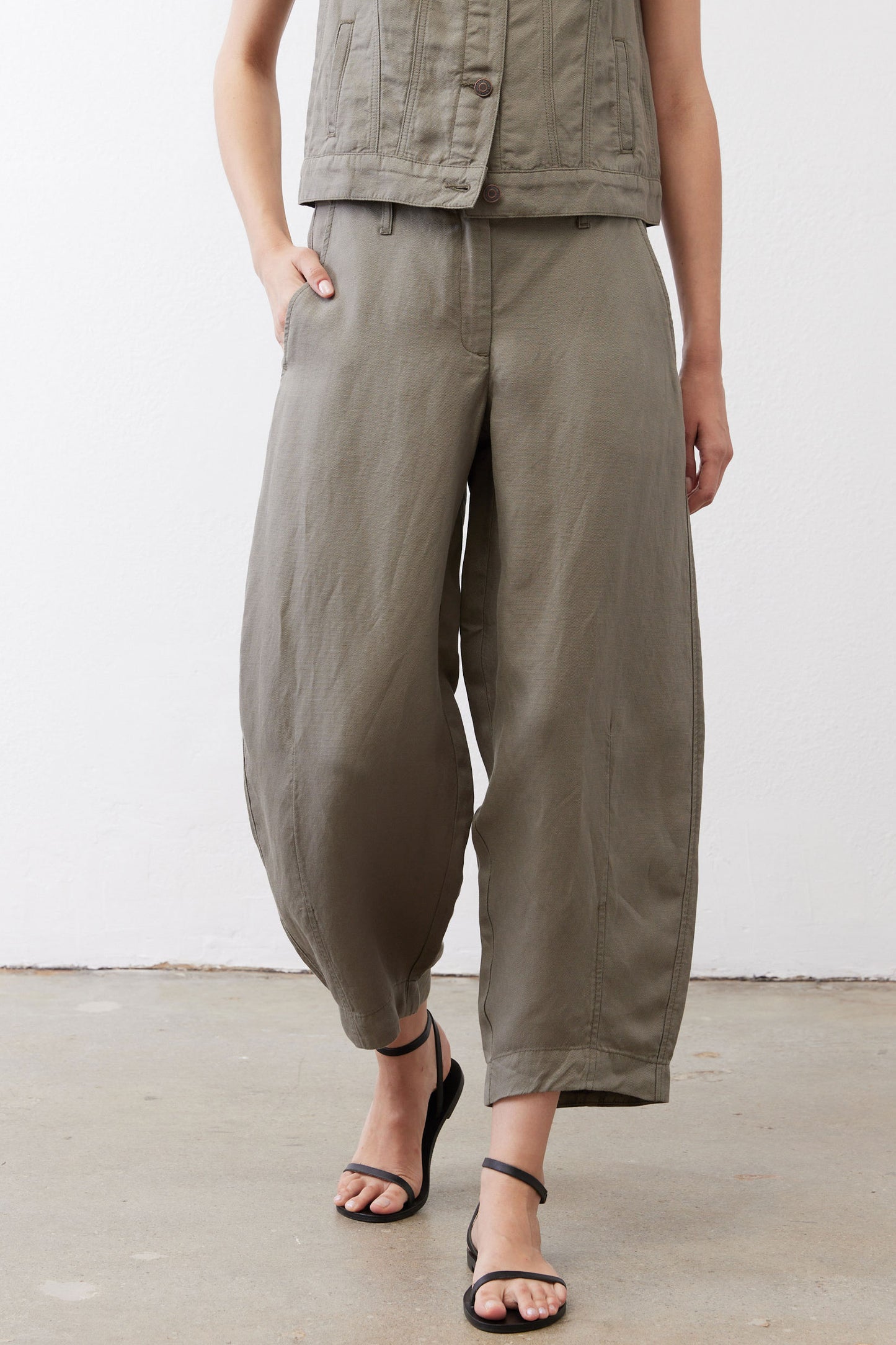 Wide-leg ankle pants in muted olive with button closure and wide cropped silhouette