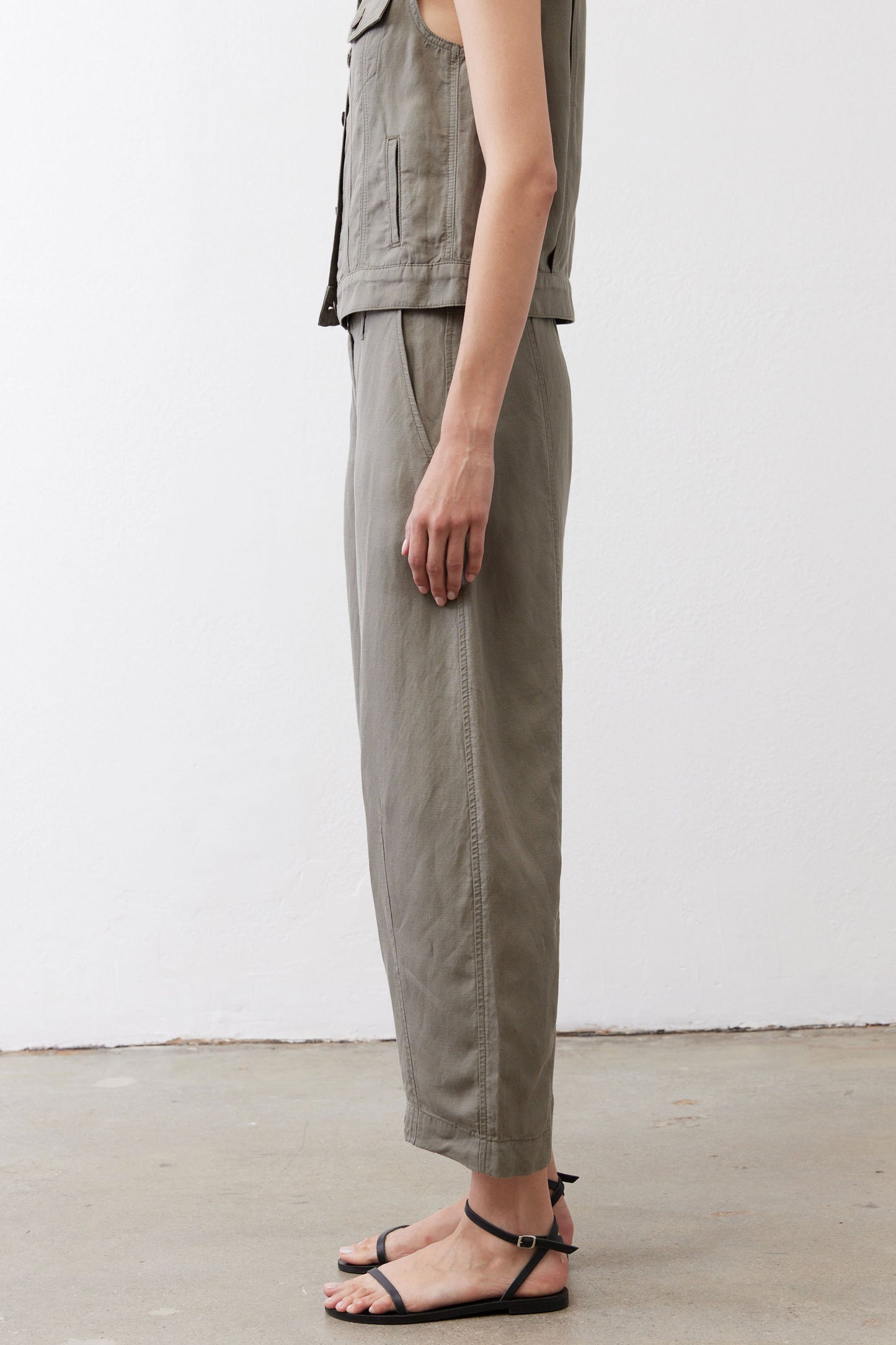 Olive wide-leg ankle pants side view with clean seams and ankle-length hem