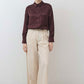 Oatmeal linen wide-leg trousers standing front view with tied waist and fluid wide legs