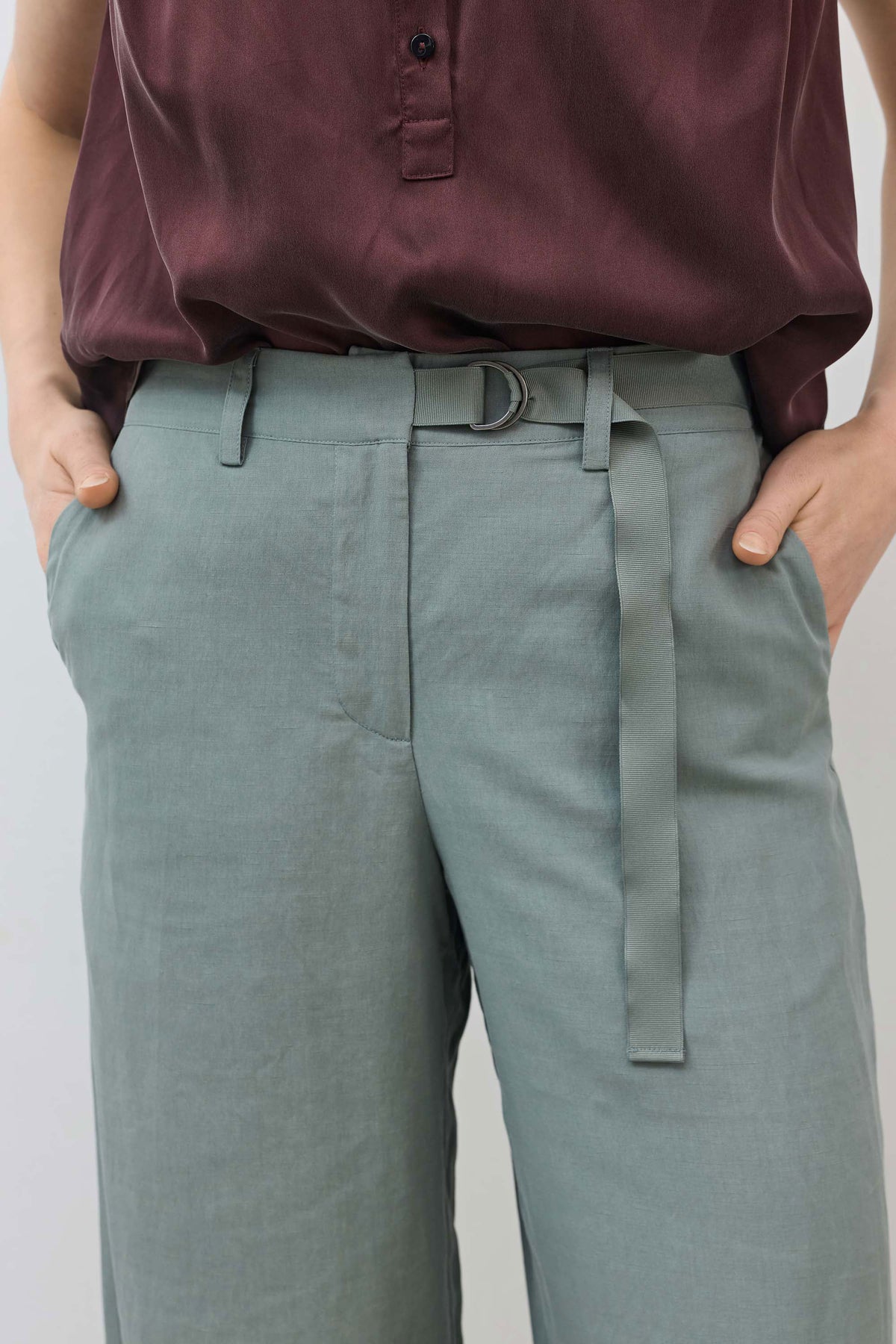 Belted waist trousers in chinois green with button front and hanging tie