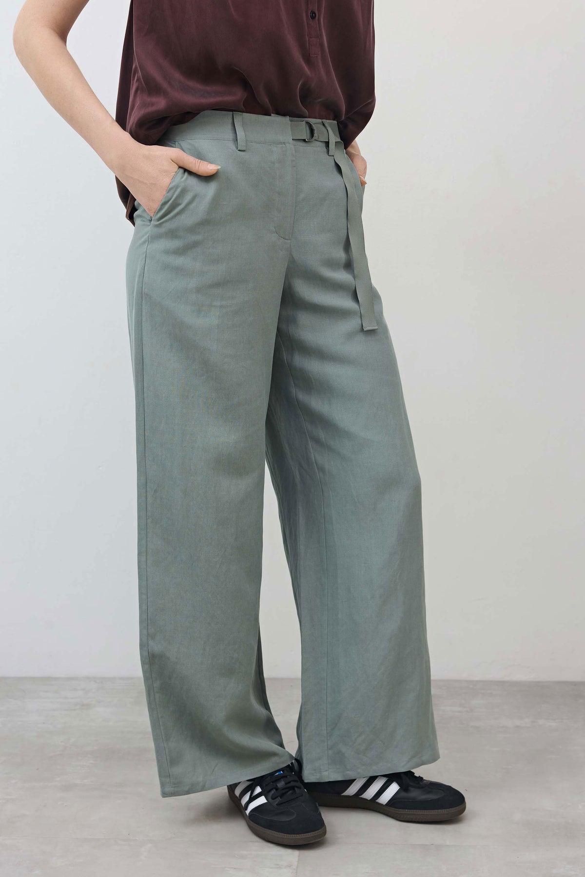 Belted wide-leg trousers in chinois green with side pockets and draped legs