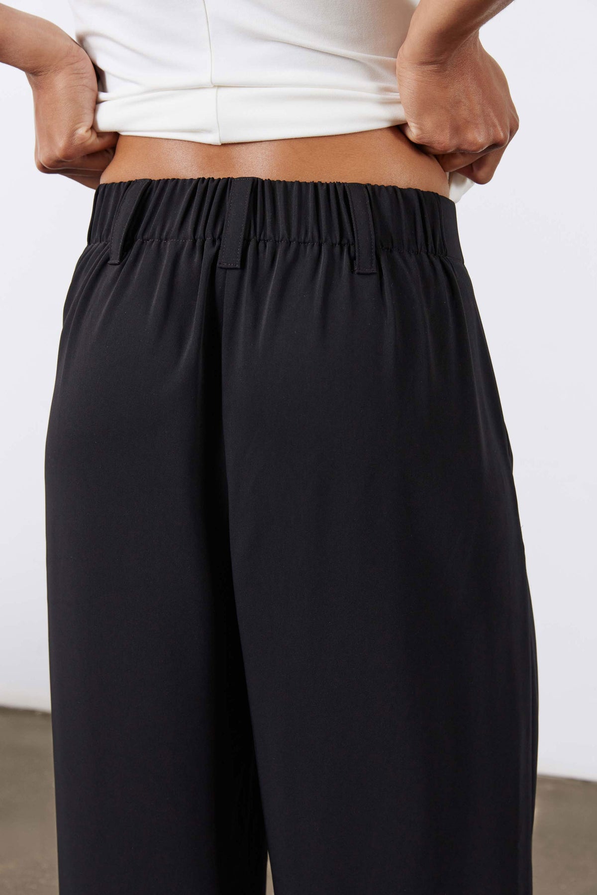 Petite black wide-leg trousers with ruched elastic waistband detail.