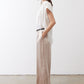 Champagne wide-leg trousers with relaxed drape, elastic waist, and black belt