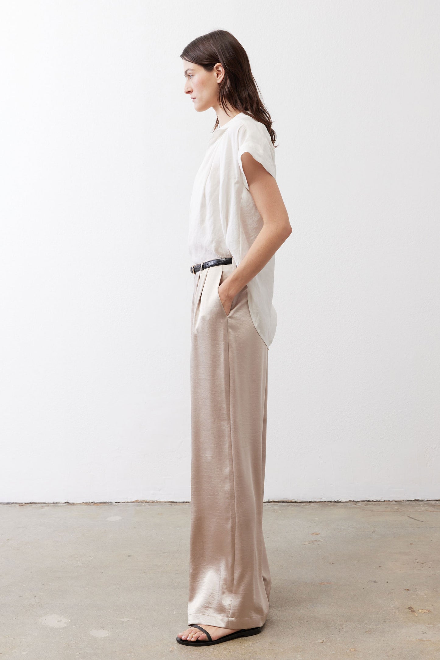 Champagne wide-leg trousers with relaxed drape, elastic waist, and black belt