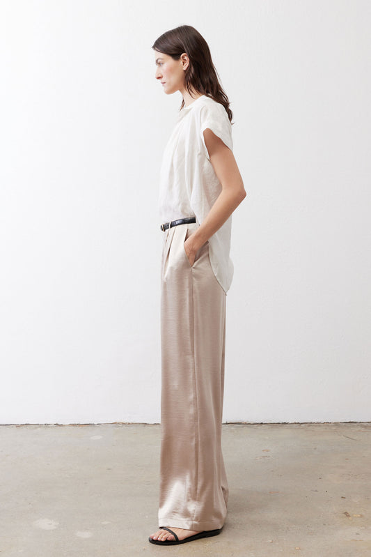 Champagne wide-leg trousers, side view, with elastic waistband and long straight legs.