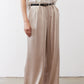 Champagne wide-leg trousers with front pleats and black belt at the waist