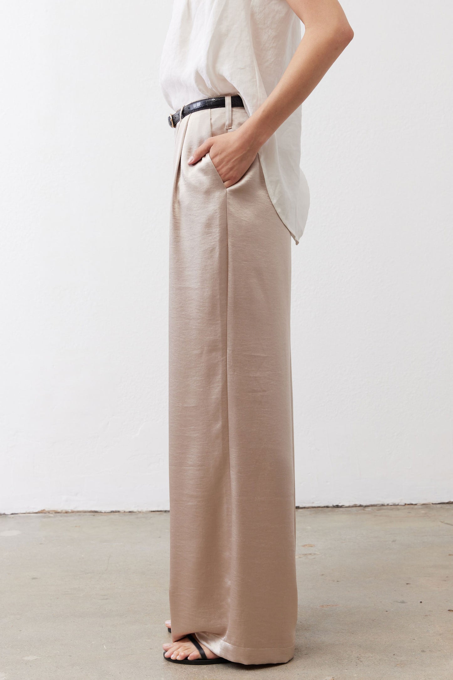 Champagne wide-leg trousers with black belt and long, wide straight legs