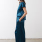 Deep teal wide-leg trousers with smooth front, belt loops, and tapered hem