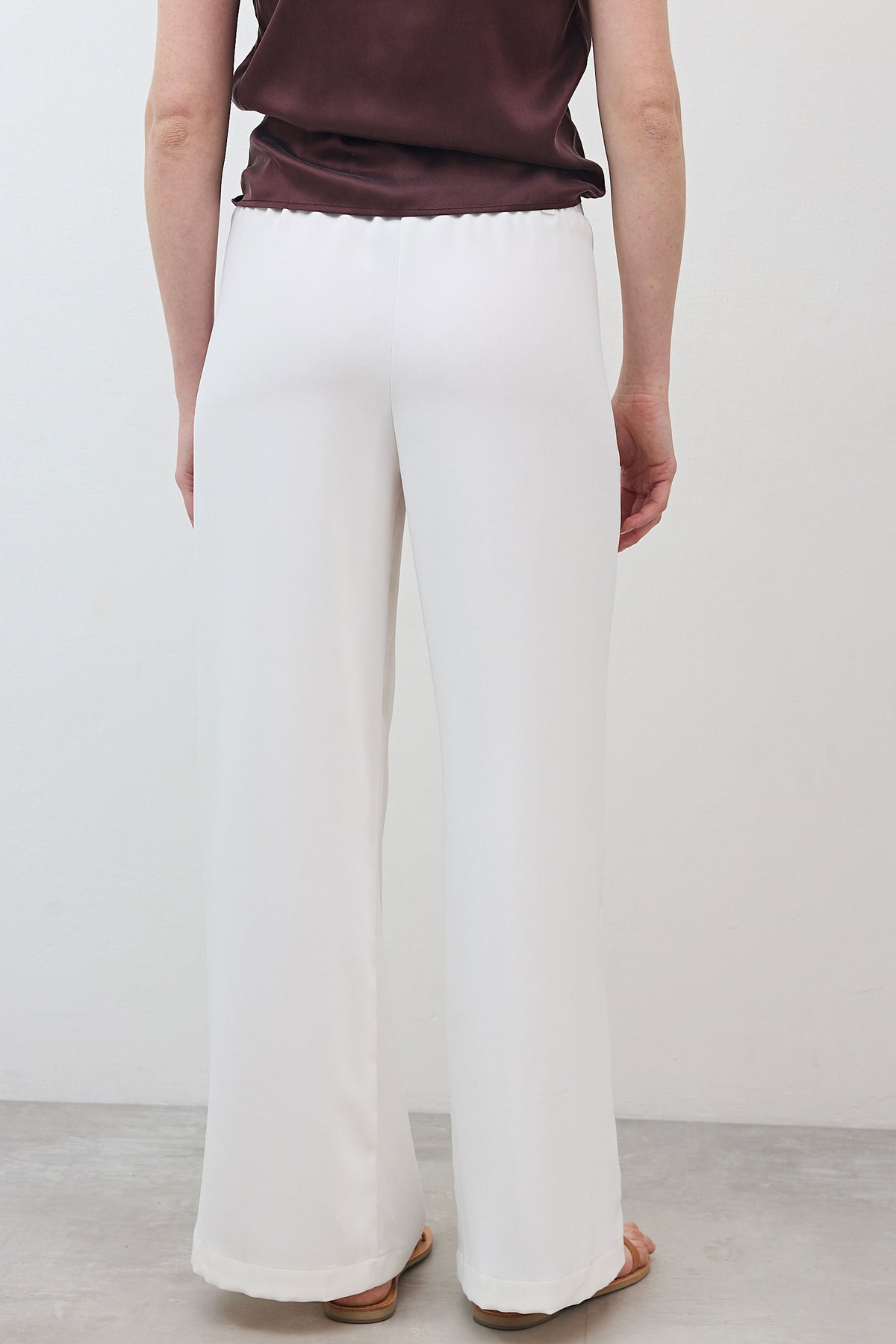 White wide-leg trousers with pleated yoke and wide flowing leg openings