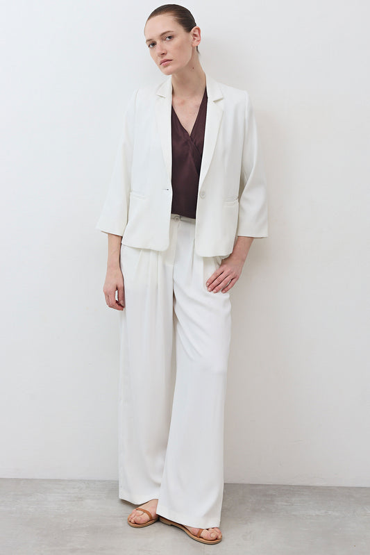 White wide-leg trousers with smooth drape and gathered elastic waist