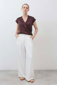 White wide-leg trousers with soft drape and pleated front