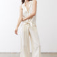 Ivory linen wide-leg trousers, angled front view with tied waist