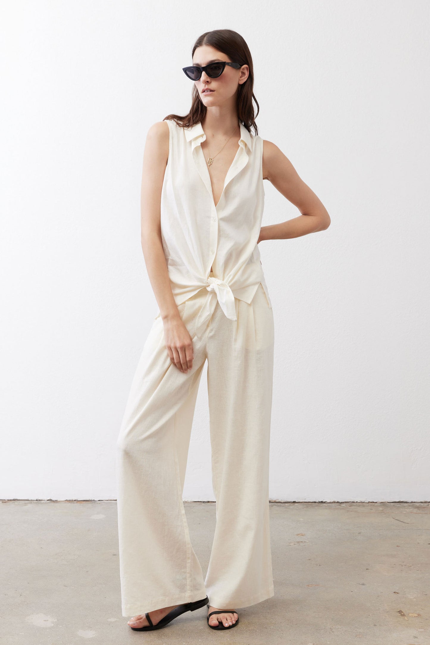 Ivory linen wide-leg trousers, front view with tied waist and long drape