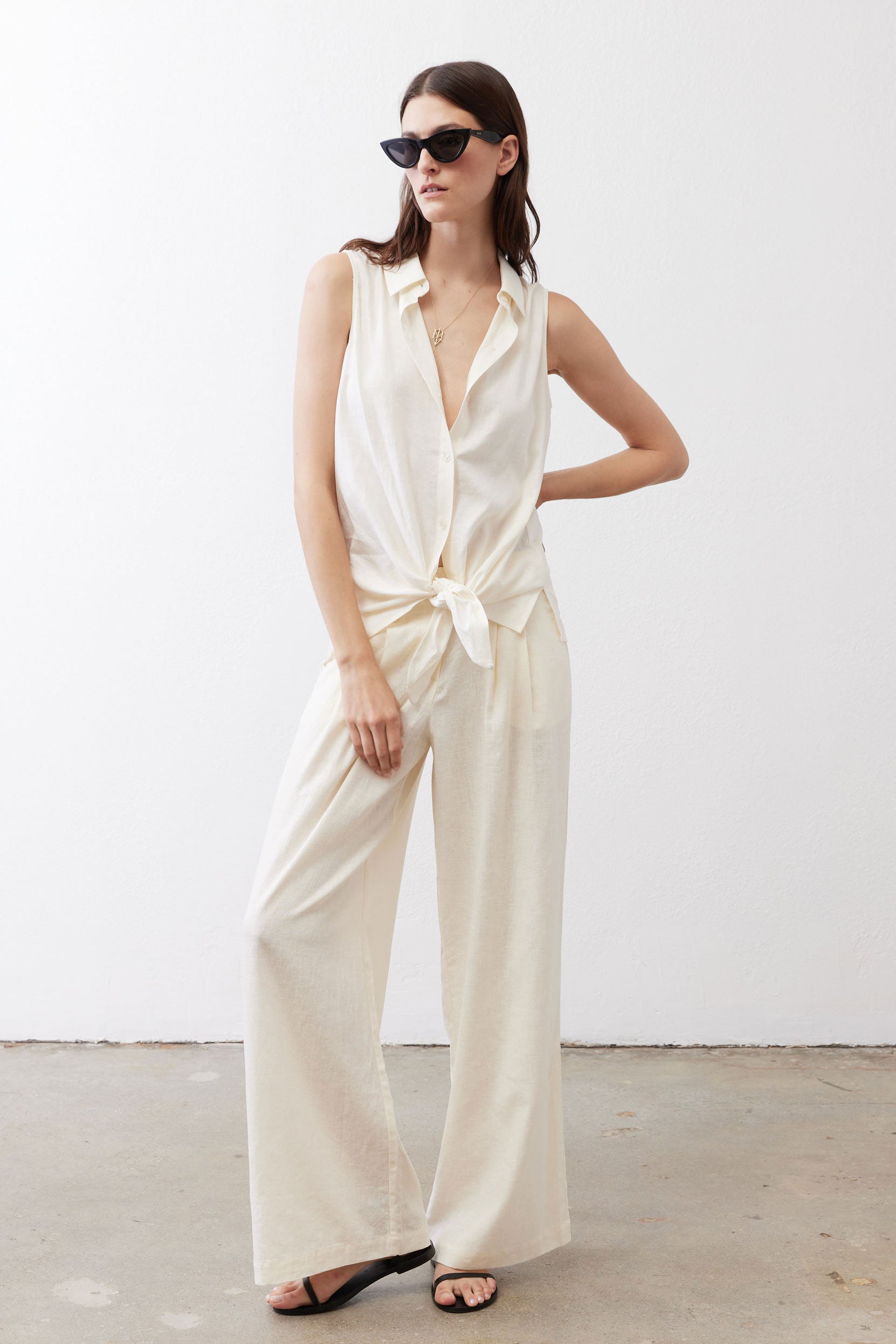 Ivory linen wide-leg trousers, front view with tied waist and long drape