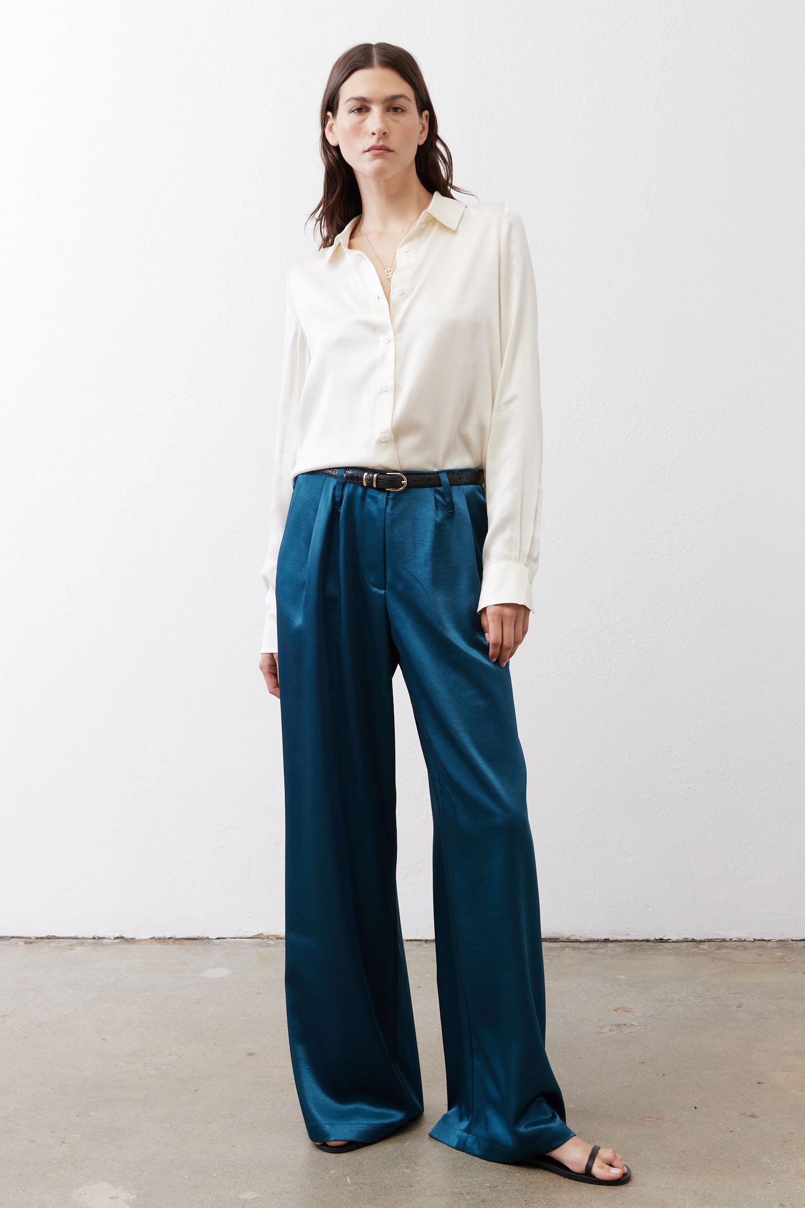 Deep teal wide-leg trousers with pleats, belt loops, and straight drape