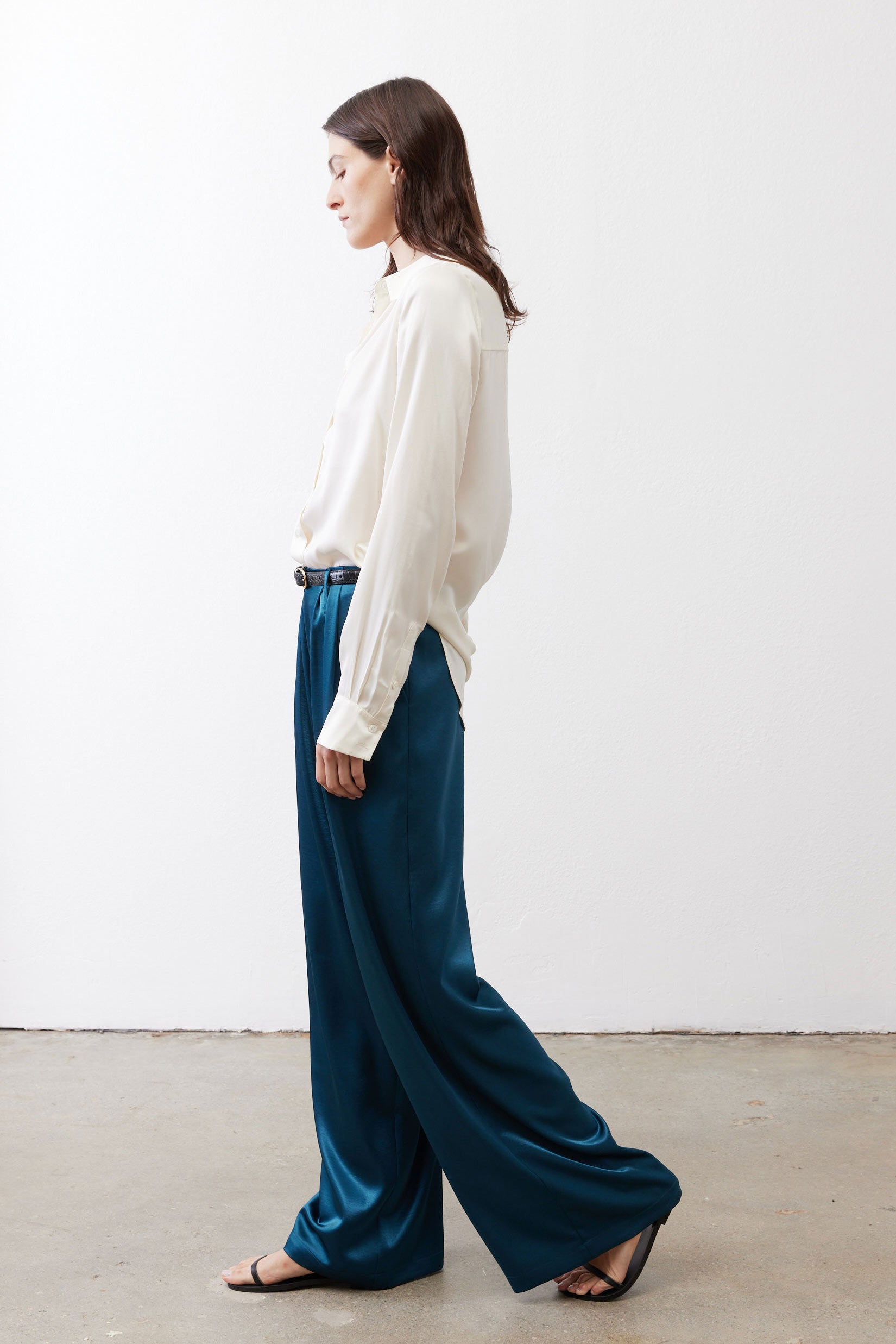Deep teal wide-leg trousers with belt loops and full-length relaxed fit