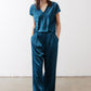 Deep teal wide-leg trousers with gathered waist and flowing leg opening