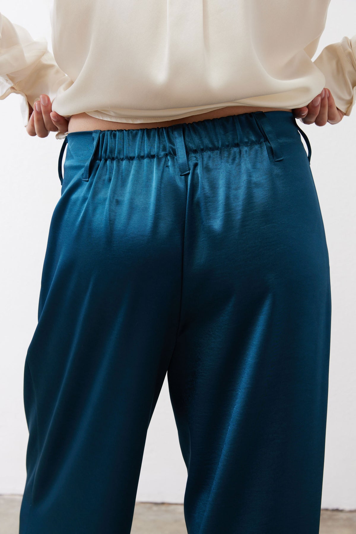 Deep teal satin wide-leg trousers with gathered elastic waistband