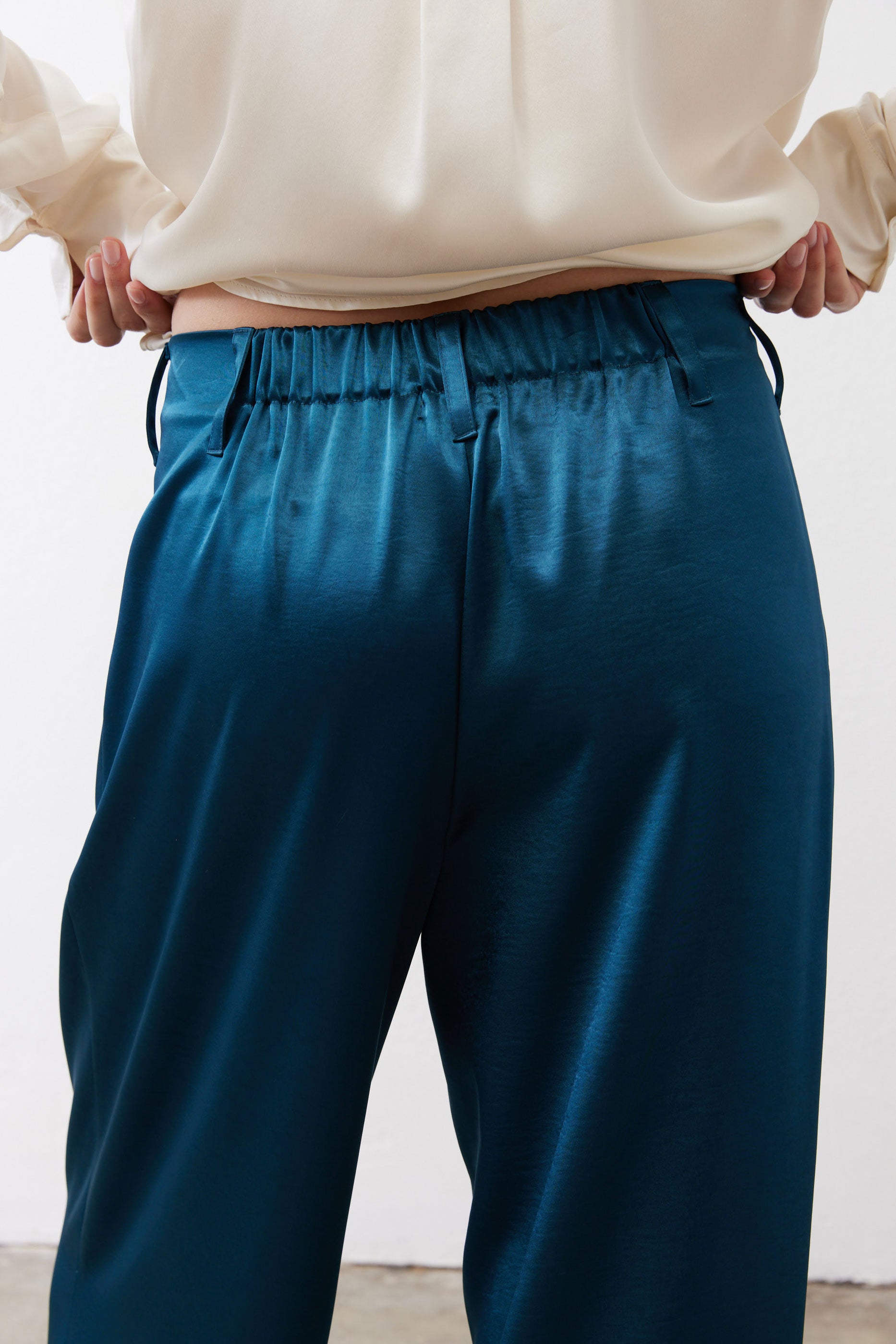 Deep teal trousers with elasticated waistband and front pockets