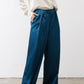 Deep teal wide-leg trousers with gathered waist and wide flared legs