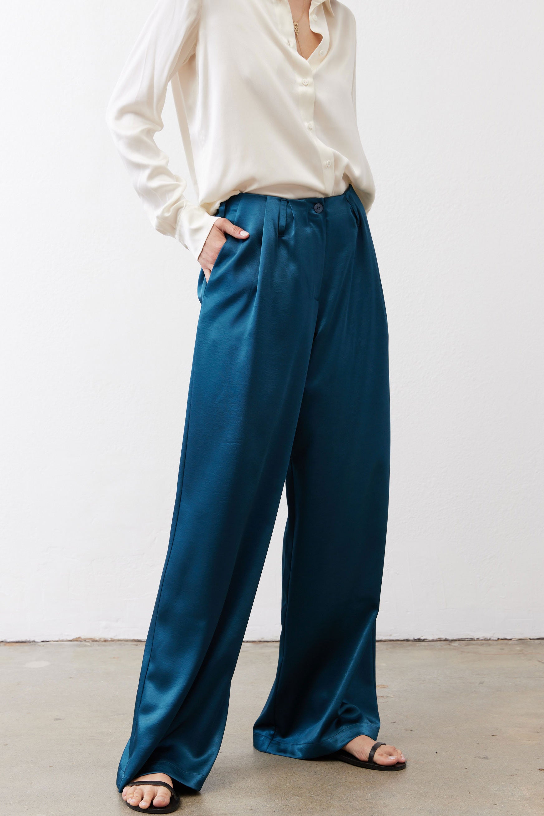 Deep teal wide-leg trousers with gathered waist and wide flared legs