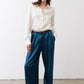 Deep teal wide-leg trousers with belt loops and pleated front