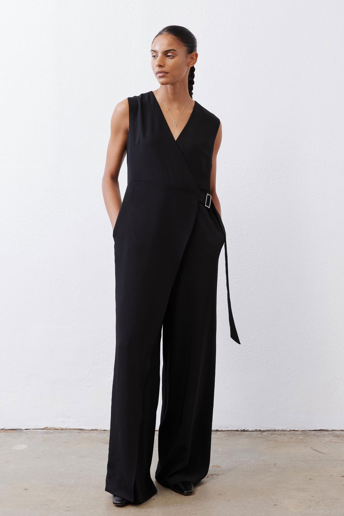 Black sleeveless wrap jumpsuit with V-neck and wide-leg silhouette