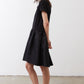 Black short-sleeve crewneck dress with gathered hem, side view, above-knee