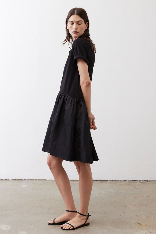 Black short-sleeve crewneck dress with gathered hem, side view, above-knee