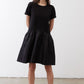 Black short-sleeve crewneck dress with gathered waist and full skirt, above-knee