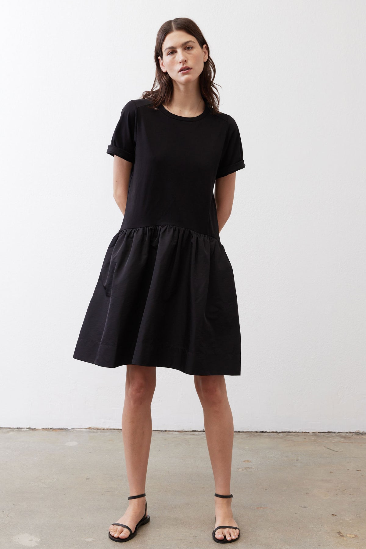Black short-sleeve crewneck dress with gathered waist and full skirt, above-knee