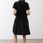 Black short-sleeve crewneck dress, back view, gathered waist and flared skirt