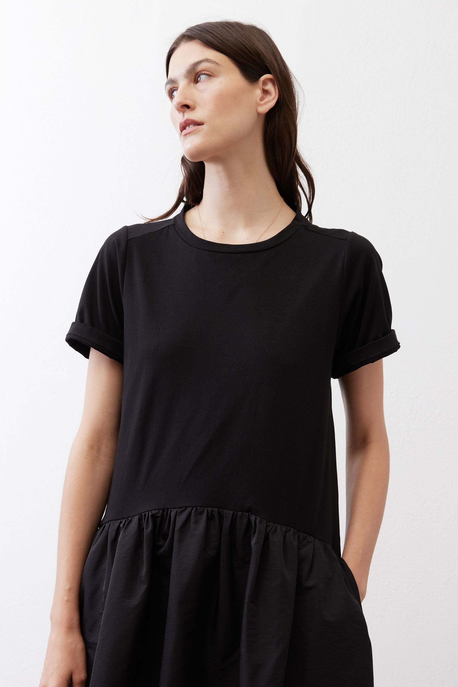 Black short-sleeve crewneck dress with gathered waist detail, close-up
