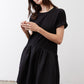 Black crewneck short-sleeve dress with tiered gathered skirt, front three-quarter view