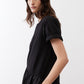 Black short-sleeve crewneck dress with gathered skirt, side profile view