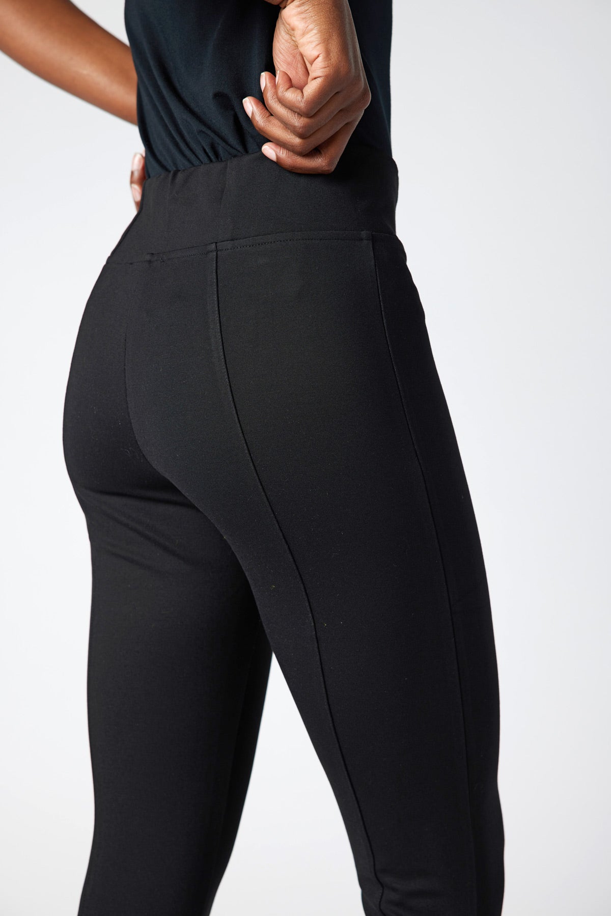 Black smart leggings with contoured panel seams and high-support waistband
